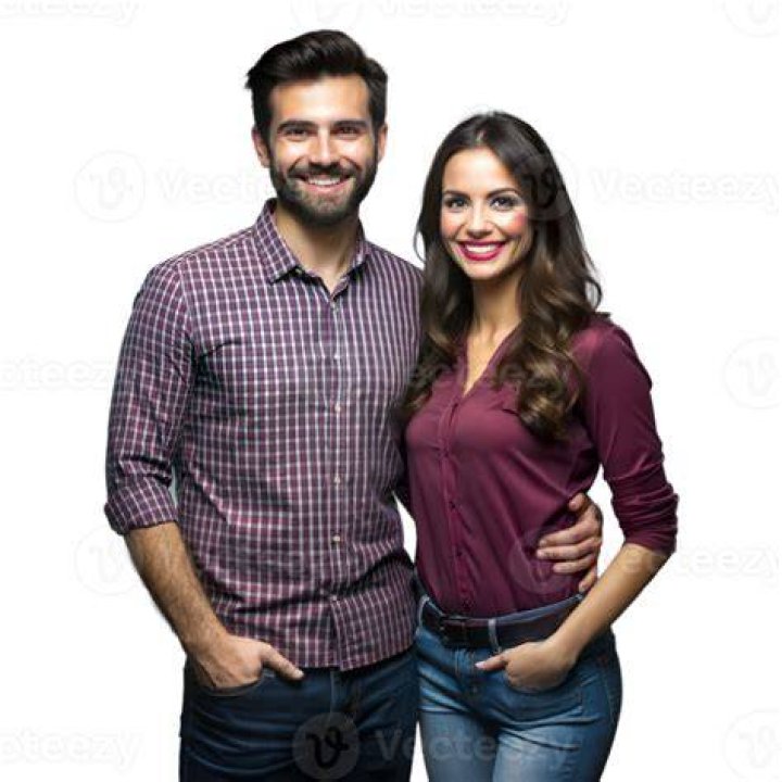a man and woman standing next to each other in formal wear at an awards