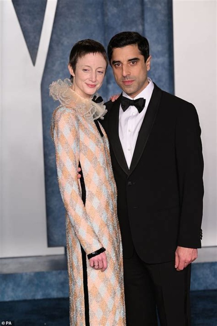 Andrea Riseborough shares a tender moment with partner Karim Saleh at
