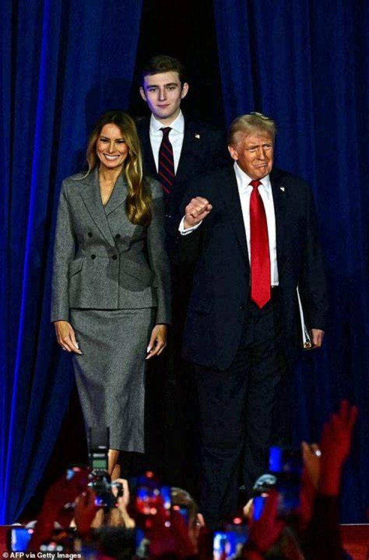 Barron Trump, 13, towers over his parents Donald and Melania Herald Sun