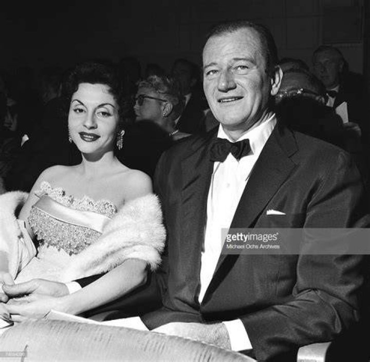 John Wayne and his wife Pilar attend a movie premiere in November
