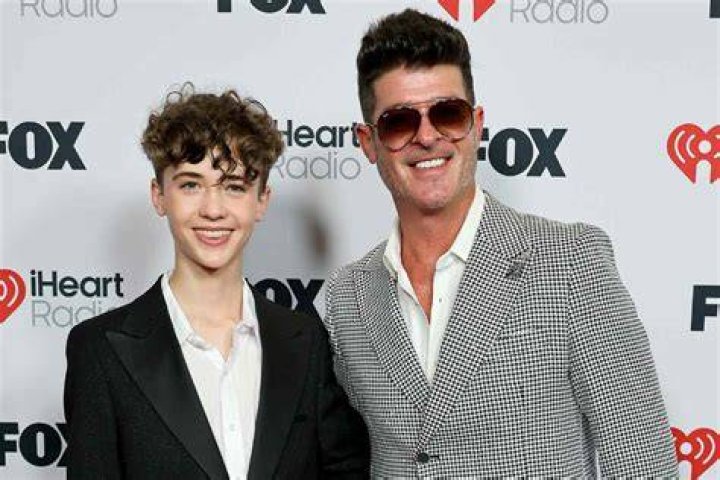 Robin Thicke, 42, and his fiancee April Love Geary, 25, look jolly for